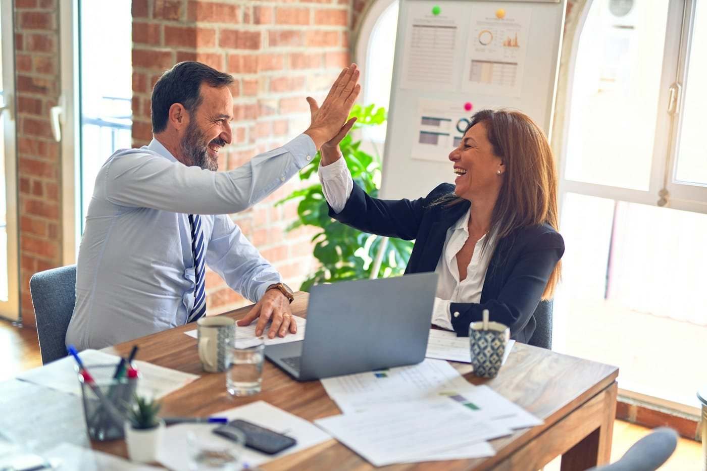 Business owner reviewing website ownership and handover documents with a developer