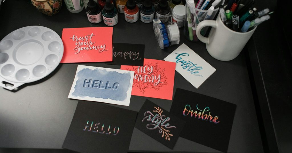 kit-formerly-convertkit-z44v7l2dIDo-unsplash Branded marketing materials laid out on a desk